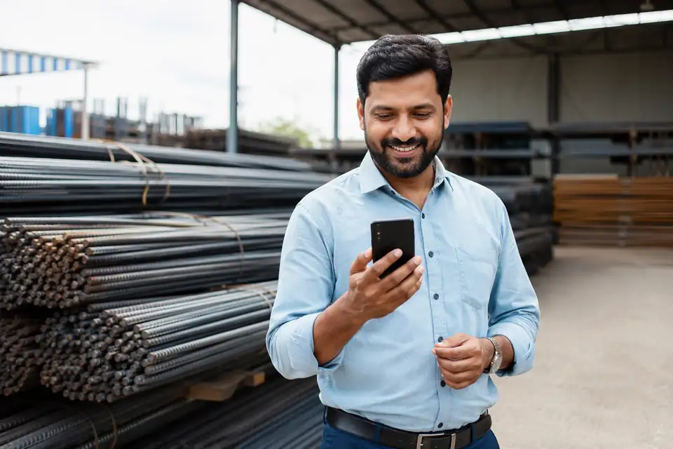 A happy TMT Steel channel partner seeing incentive progress on his phone with Unotag